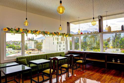 a restaurant with tables and chairs and large windows at Mint Hotel in Arequipa