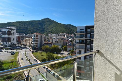 a view of a city from the balcony of a building at BARBETA Accommodation in Budva