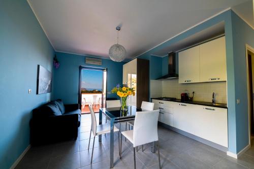 a kitchen and dining room with a table and chairs at Residence l'Ogliastro in Petrizzi