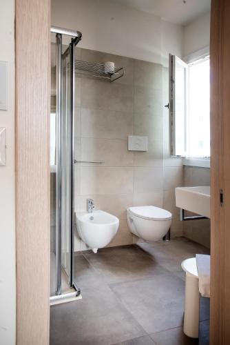 a bathroom with a shower and a sink and a toilet at Hotel Solemare - Frontemare - 3 Stelle Superior in Lido di Jesolo