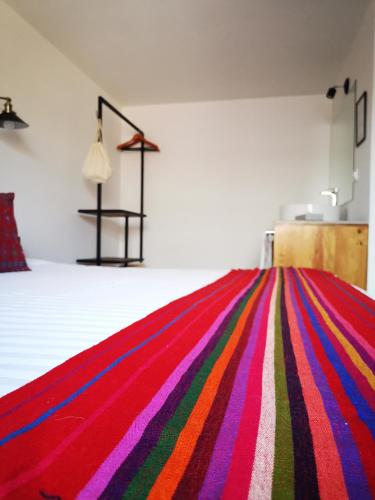 a room with a colorful striped rug on the floor at Santa Josefita B&B in Cholula