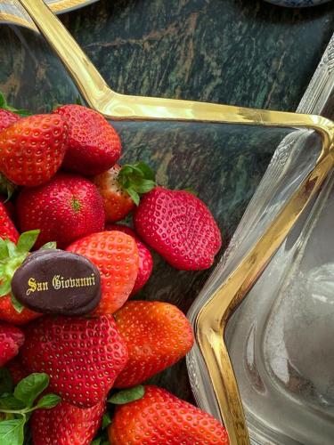 a bunch of strawberries with a cookie on top of them at San Giovanni Stanly Hotel in Alexandria