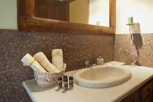 a bathroom counter with a sink and a mirror at Private Villa with Panoramic View in Ayía Evthimía