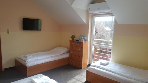Кровать или кровати в номере Hotelik SJ