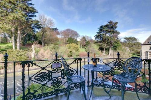 a patio with two tables and chairs on a fence at Pannett View in Whitby