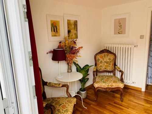 a room with two chairs and a table and a lamp at ROOFTOP TERRACE Domus dei fabbri in Venice
