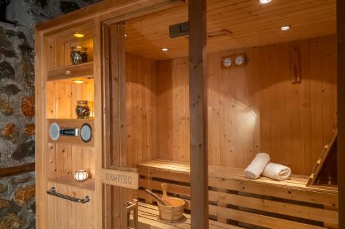 a wooden bathroom with a sauna at ROUGA Mountain Boutique Suites & Spa in Palaios Agios Athanasios