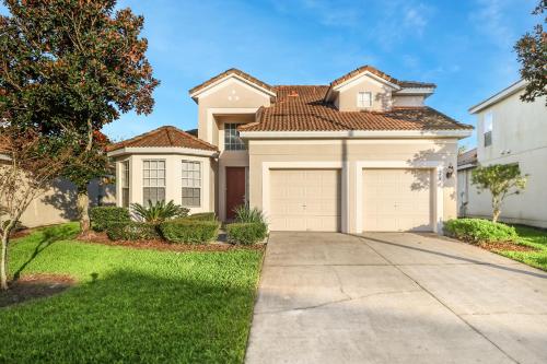 a large house with a garage at Windsor Hills Resort 5BR Villa, Amenities, Private Pool & Water Park, Near Disney, Sea World, Universal in Orlando