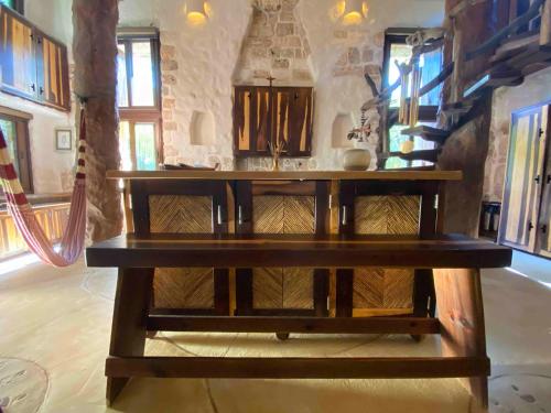 a wooden table in a living room with a table at Sueños Tulum in Tulum
