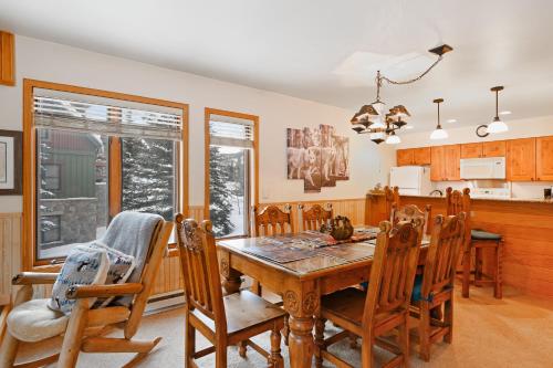 a dining room with a wooden table and chairs at Ski Run Condominiums #108 in Keystone