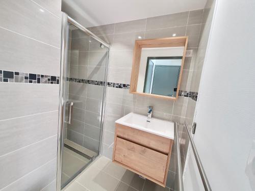 a bathroom with a shower and a sink and a mirror at Les Chamois in Lajoux