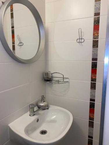 a bathroom with a sink and a mirror at Penzión Fistra in Fričkovce