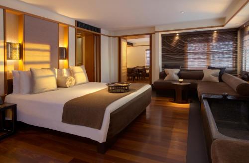 a bedroom with a large bed and a living room at The Setai, Miami Beach in Miami Beach