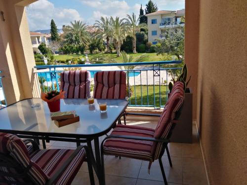 a balcony with a table and chairs and a view at Paradise Gardens II Anastasia Apartment in Paphos