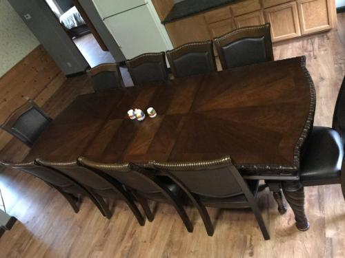 a dining room table with black chairs around it at Mountain Trail Lodge and Vacation Rentals in Oakhurst