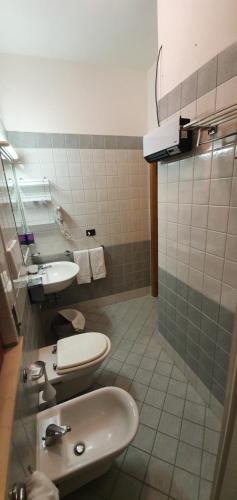 a bathroom with a sink and two toilets in it at La Lanterna in Silvi Marina