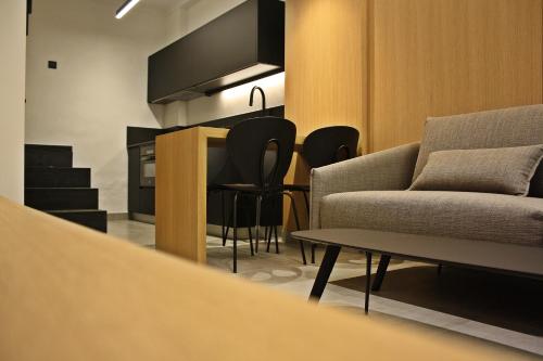 a living room with a couch and a table and chairs at LA ALMACERÍA DE ANTEQUERA in Antequera