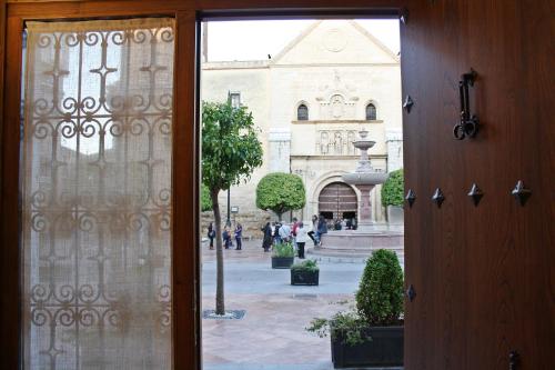 a view of a building through a glass door at LA ALMACERÍA DE ANTEQUERA in Antequera