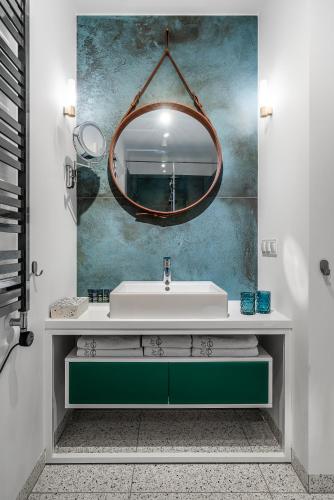 a bathroom with a sink and a mirror at Apartament Ap175 in Gdańsk