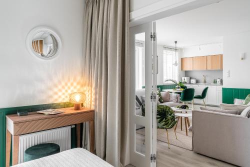 a bedroom with a living room and a kitchen at Apartament Ap175 in Gdańsk