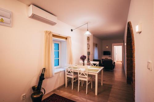 a dining room and living room with a table and chairs at Latron 98 in Český Krumlov