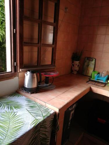 a kitchen with a counter top and a stove at The Kapokier in Saint-Pierre