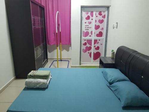 a room with a large bed and pink and purple curtains at langkawi homestay murah empat bilik in Kuah