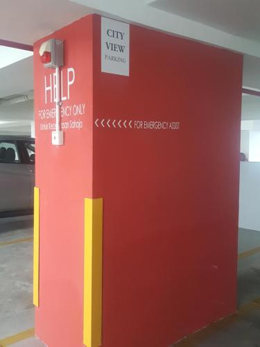 a red and yellow machine in a parking lot at Cityview Homestay Seksyen 13 Shah Alam, Aeon Mall, Stadium, I-City in Shah Alam