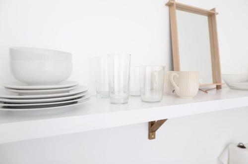 a shelf with plates and cups and a mirror at The Burlington in Los Angeles