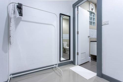 a bathroom with a glass door and a mirror at P1 Silom Pan large room full kitchen WIFI 4-6pax in Bangkok