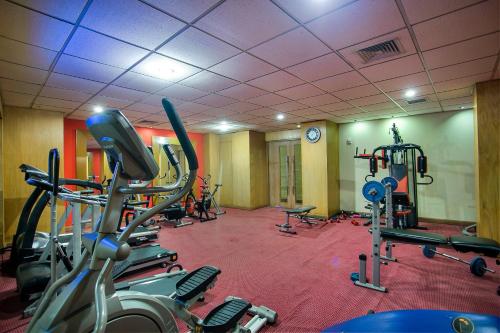 a gym with several tread machines in a room at Rose View Hotel in Sylhet