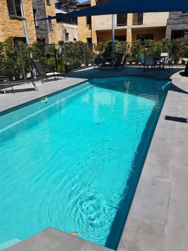 a large blue swimming pool in a building at 22 Gillies Street Apartments in Warrnambool