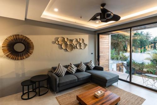 a living room with a couch and a table at Zee Luxury Boutique Hotel in Hinkong