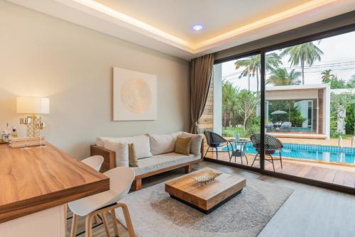 a living room with a couch and a table at Zee Luxury Boutique Hotel in Hinkong