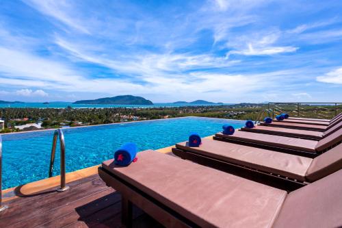 a swimming pool with a view of the water at The View Rawada Phuket in Rawai Beach