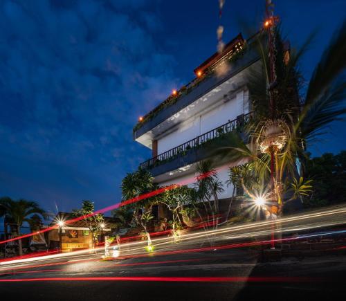 a building with lights on a street at night at Dreamland View in Uluwatu