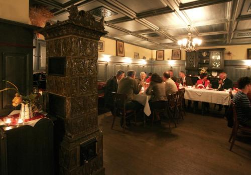 a group of people sitting at tables in a restaurant at Landgasthof Zum Kirchenwirt in Kellberg
