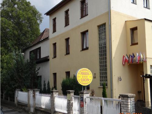 a yellow sign in front of a building at Pension Europa in Prague
