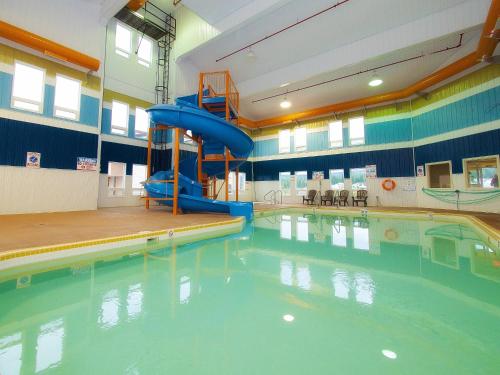 a swimming pool with a slide in the middle at BCMInns - Hinton in Hinton