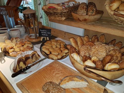 a table with different types of breads and pastries at Gröbl-Alm in Mittenwald