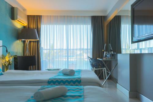 Ένα ή περισσότερα κρεβάτια σε δωμάτιο στο Efe Hotel