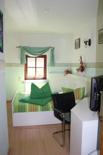 a room with a bed and a window and a chair at Doppelzimmer-in-Wiesa in Thermalbad Wiesenbad