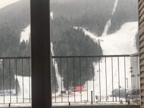 a view of a snow covered mountain from a window at Studio&apartments Snow in Bjelašnica