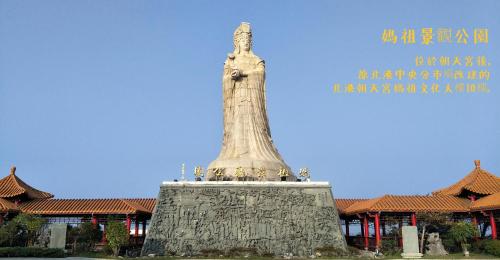 a statue in front of a building at Ponkan Inn in Beigang