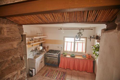 a kitchen with a stove and a stove top oven at Le Case di Felicita in Santa Teresa Gallura