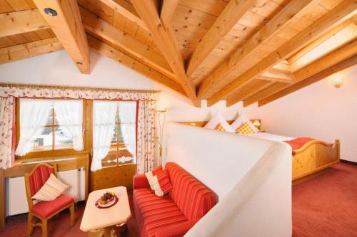 a bedroom with a bed and a couch in a room at Landhaus Mayer in Oberstdorf