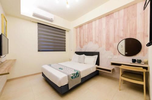Una cama o camas en una habitación de 綠時光民宿