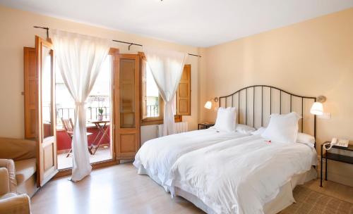 Кровать или кровати в номере Hotel Rincon de Traspalacio