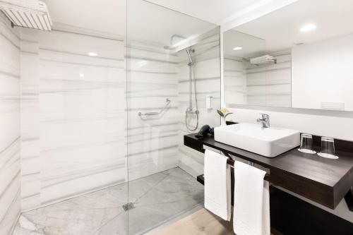a bathroom with a sink and a glass shower at Hotel Atlantic El Tope in Puerto de la Cruz