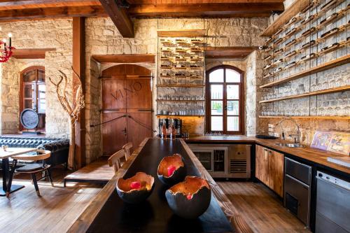 a kitchen with a counter with fruit bowls on it at VİNO ALAÇATI in Alaçatı